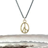 A gold peace sign pendant necklace with salt and pepper diamond accents on an oxidized sterling silver chain