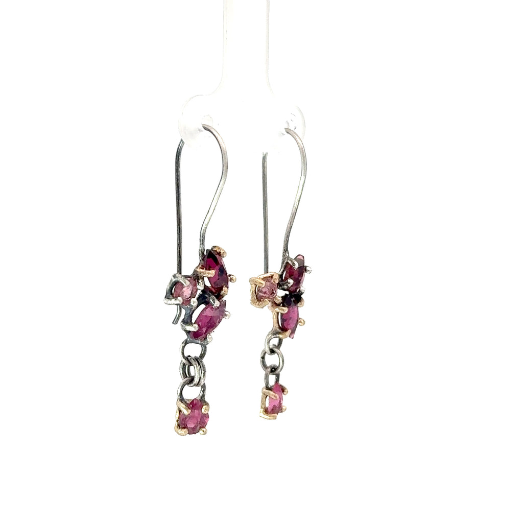 Pair of earrings with pink gemstones on a white background