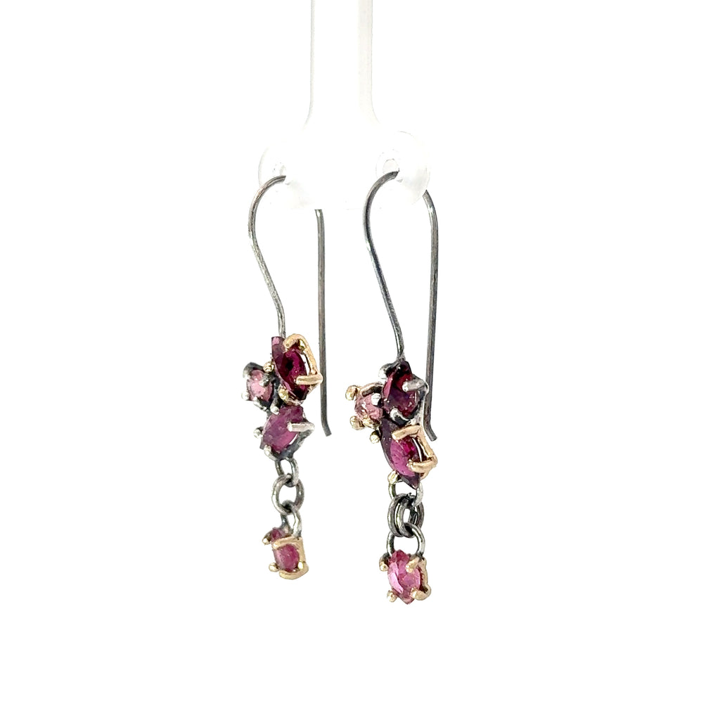 Pair of earrings with pink tourmalines on a white background