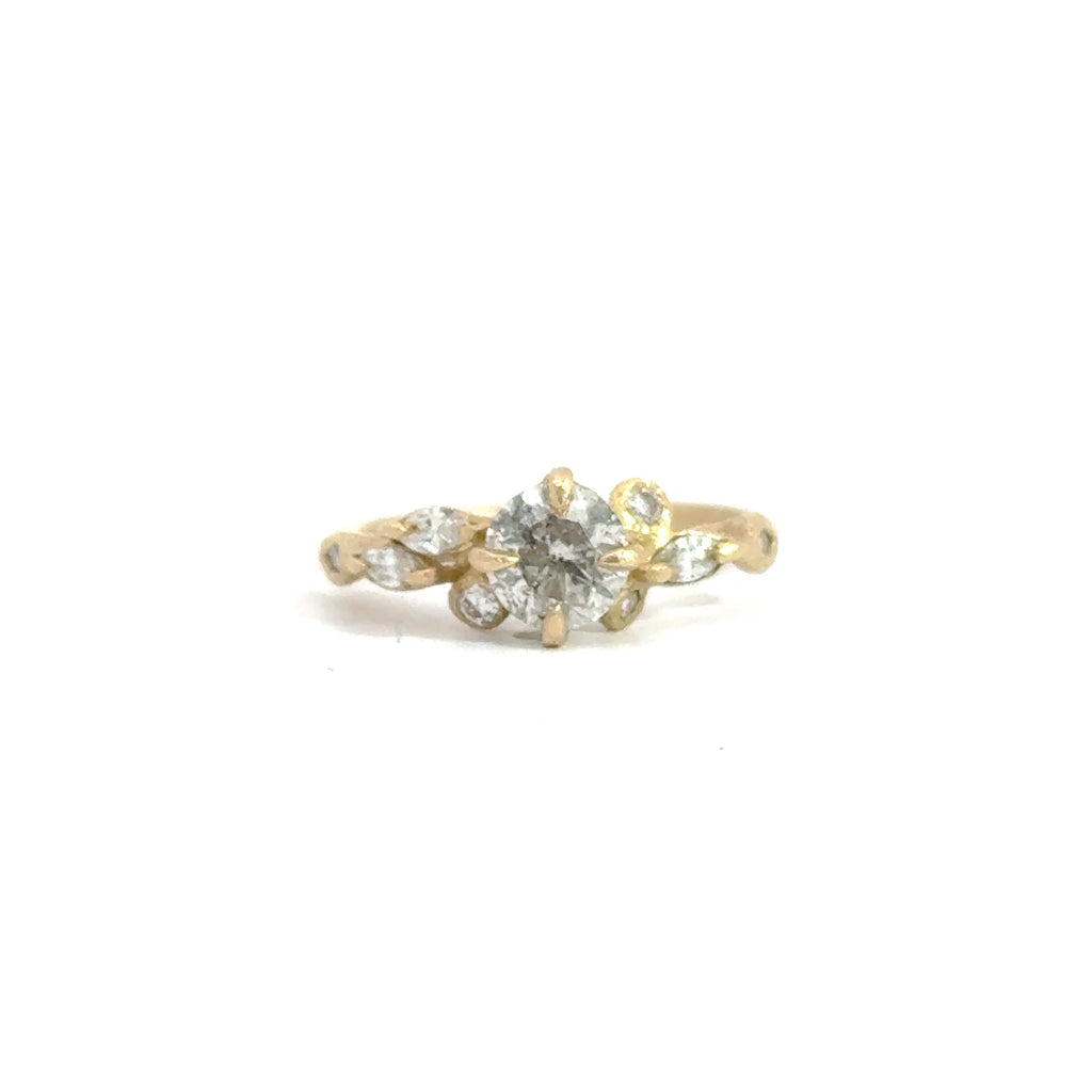 Gold ring with a diamond on a white background